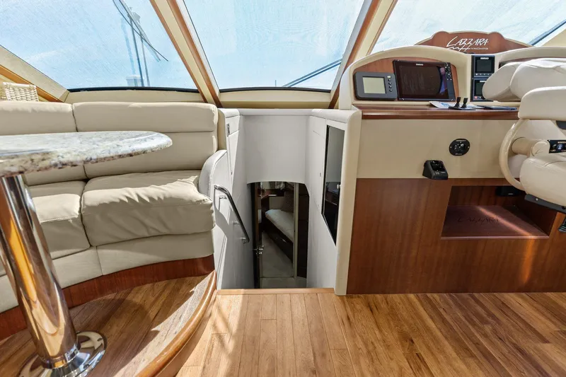  Yacht Photos Pics Luxurious Lazzara yacht interior with plush seating and modern helm station.