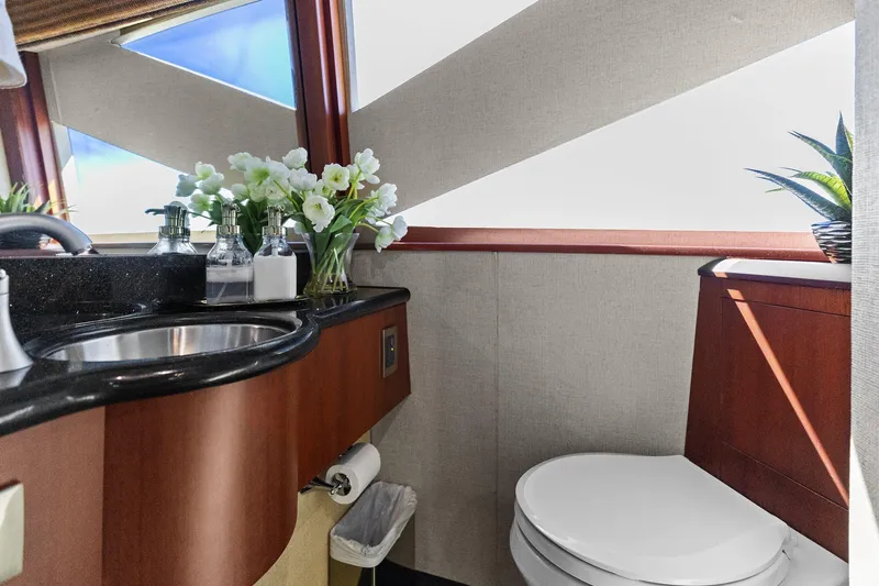  Yacht Photos Pics Luxurious Lazzara yacht bathroom with elegant sink, flowers, and modern decor.