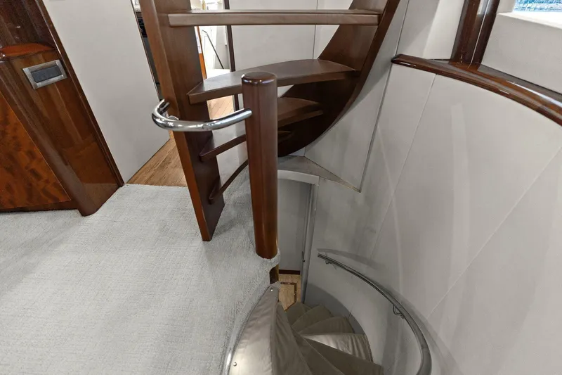  Yacht Photos Pics Spiral staircase inside a Lazzara yacht with wooden and metal accents.