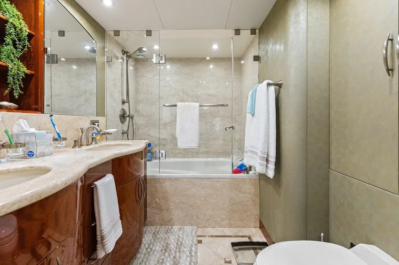  Yacht Photos Pics Luxurious Lazzara yacht bathroom with marble countertops, glass shower, and elegant fixtures.