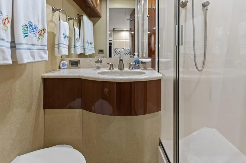  Yacht Photos Pics Luxurious Lazzara yacht bathroom with elegant sink, shower, and decorative towels.