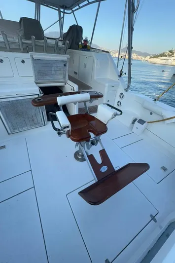  Yacht Photos Pics 2004 Cabo 45 Express Los Suenos Edition boat deck with fishing chair and ocean view.