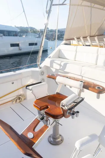  Yacht Photos Pics 2004 Cabo 45 Express Los Suenos Edition yacht cockpit with fishing chair and rod holders.