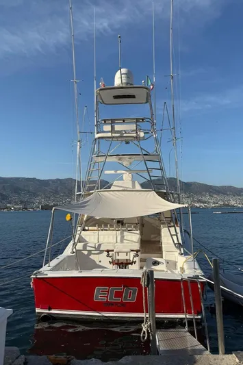  Yacht Photos Pics 2004 Cabo 45 Express Los Suenos Edition boat docked with red hull and fishing tower.