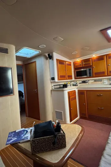  Yacht Photos Pics 2004 Cabo 45 Express Los Suenos Edition yacht interior with wood cabinetry and modern amenities.