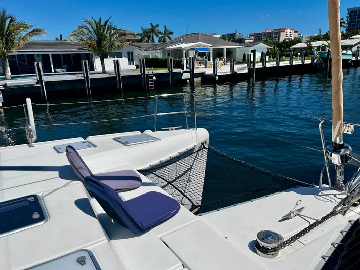  Yacht Photos Pics Lagoon 420 catamaran docked by waterfront homes, sunny day, 2009 model.