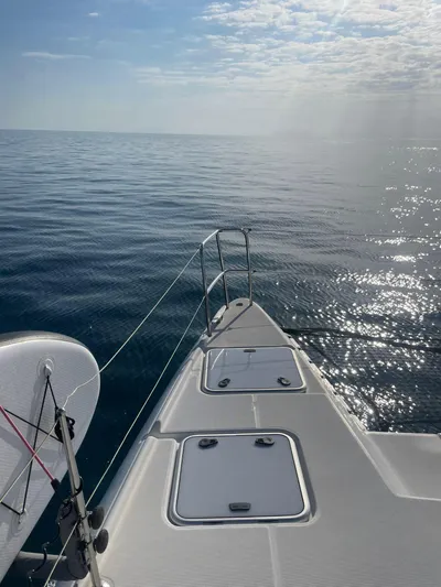  Yacht Photos Pics Bow of 2009 Lagoon 420 catamaran sailing on calm ocean under clear sky.