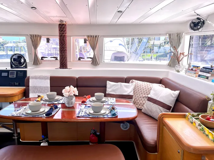  Yacht Photos Pics Luxurious interior of a 2009 Lagoon 420 catamaran with elegant dining setup.