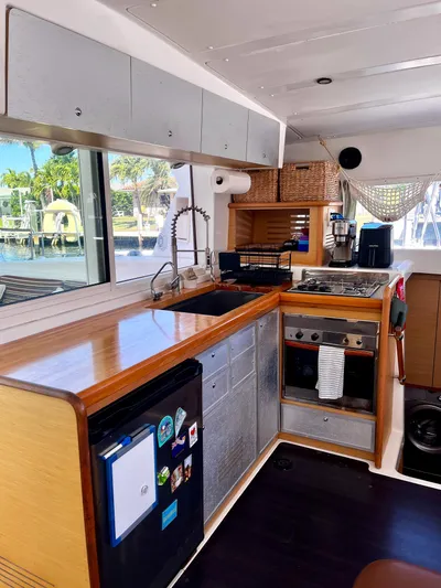  Yacht Photos Pics 2009 Lagoon 420 yacht kitchen with modern appliances and wooden cabinetry.