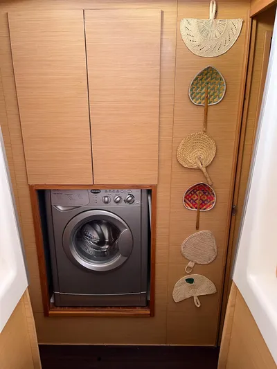  Yacht Photos Pics 2009 Lagoon 420 interior with washing machine and decorative wall hangings.