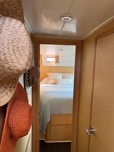  Yacht Photos Pics Interior of 2009 Lagoon 420 yacht with cozy bedroom and hanging hats.