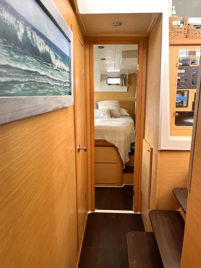 Yacht Photos Pics Interior of 2009 Lagoon 420 yacht, featuring cozy bedroom and wooden paneling.