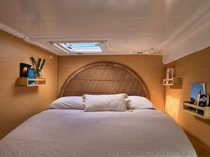  Yacht Photos Pics Cozy bedroom interior of 2009 Lagoon 420 yacht with skylight and wooden shelves.