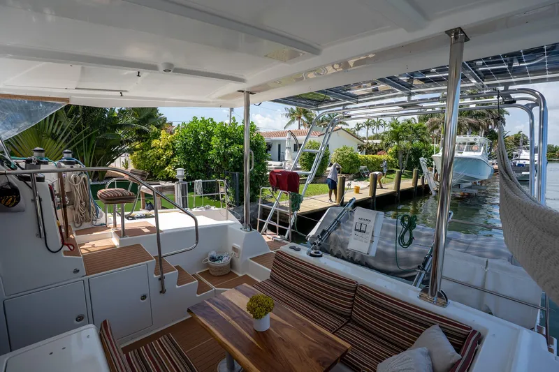  Yacht Photos Pics 2009 Lagoon 420 yacht interior with seating area, docked by lush greenery.