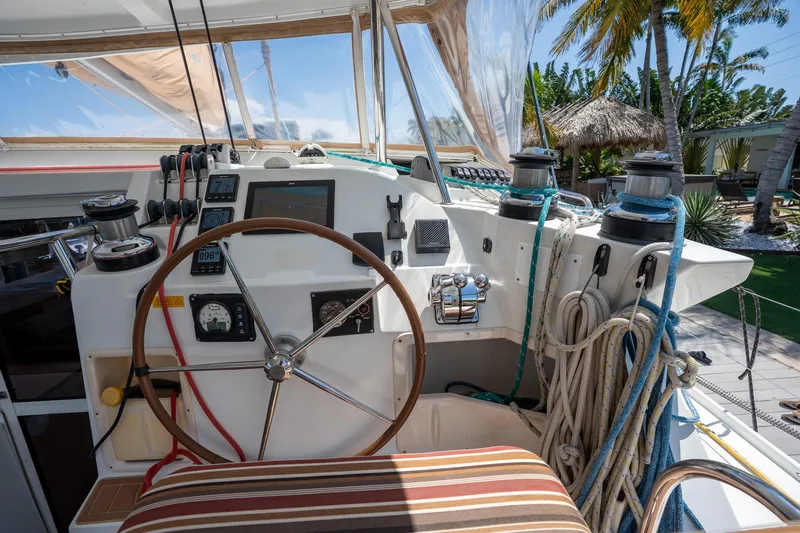  Yacht Photos Pics Cockpit of 2009 Lagoon 420 sailboat with steering wheel, ropes, and navigation instruments.