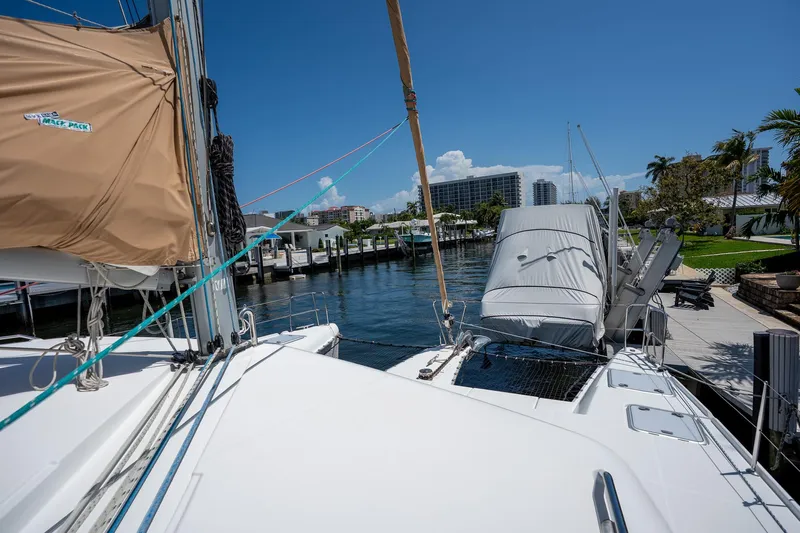  Yacht Photos Pics 2009 Lagoon 420 catamaran docked in a sunny marina with clear blue skies.