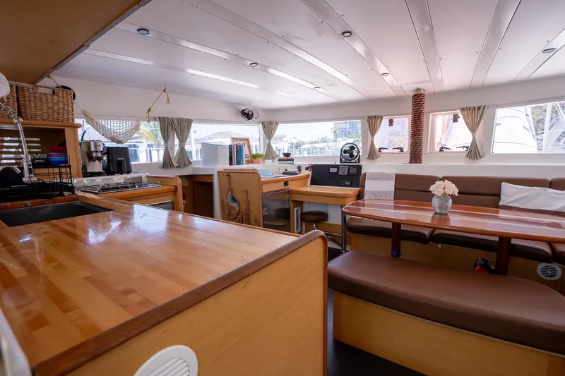  Yacht Photos Pics Interior of 2009 Lagoon 420 catamaran with wooden furnishings and spacious seating area.