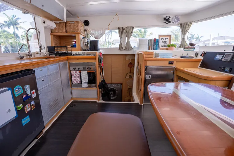  Yacht Photos Pics Interior of 2009 Lagoon 420 yacht kitchen with modern appliances and wooden finishes.