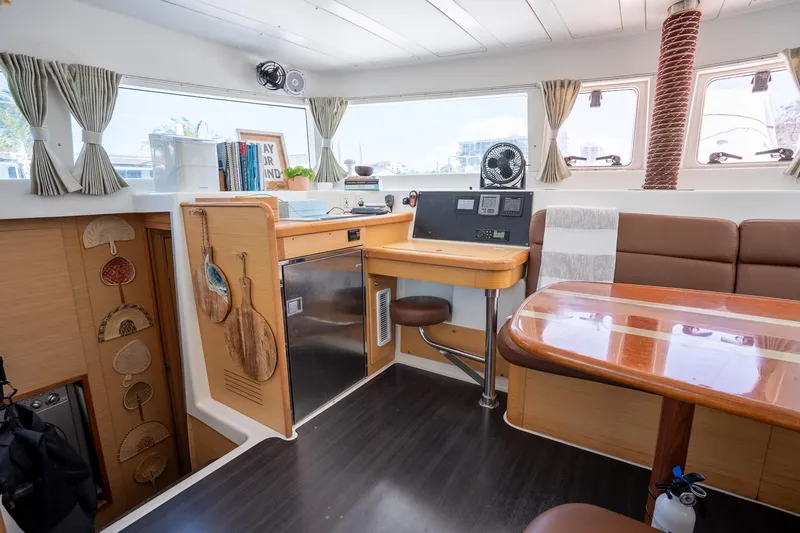  Yacht Photos Pics Interior of 2009 Lagoon 420 catamaran with dining area and navigation station.