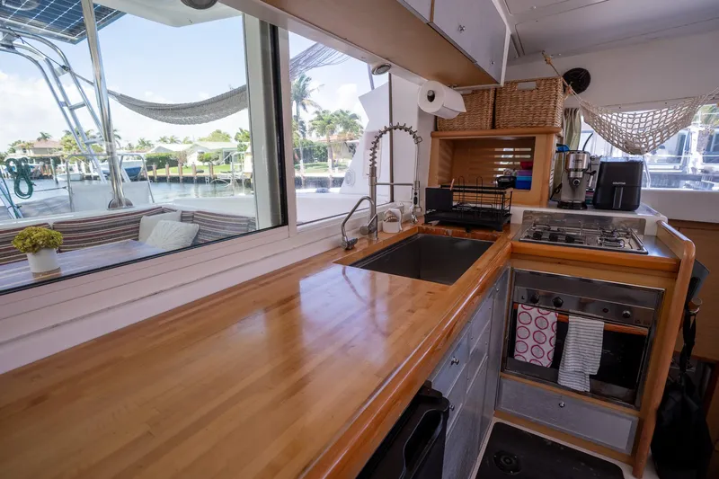  Yacht Photos Pics Interior of 2009 Lagoon 420 yacht kitchen with wooden countertops and modern appliances.