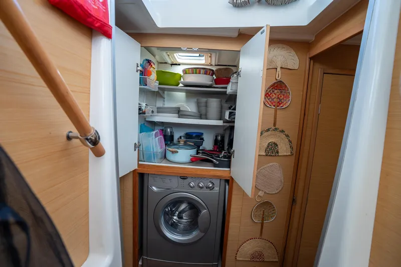  Yacht Photos Pics Compact kitchen area in a 2009 Lagoon 420 yacht with washing machine and storage shelves.