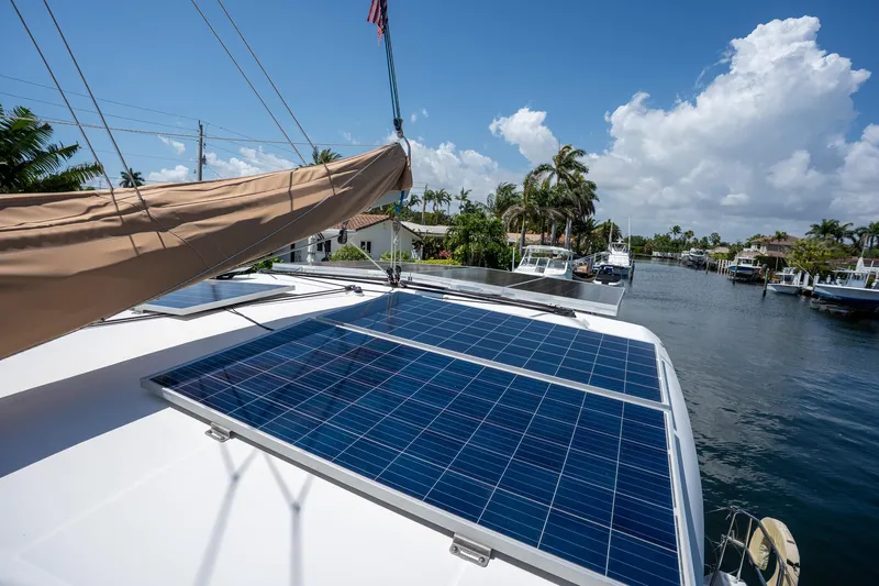  Yacht Photos Pics Lagoon 420 catamaran with solar panels, docked in a sunny canal, 2009 model.