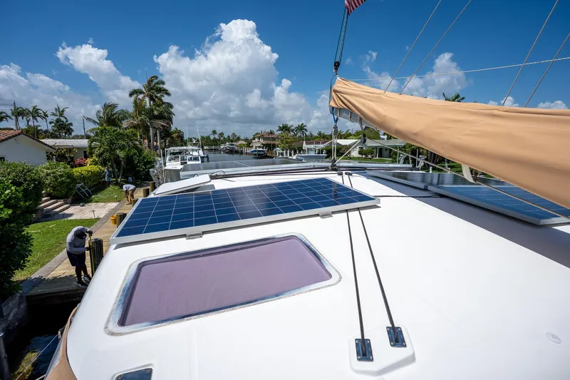  Yacht Photos Pics 2009 Lagoon 420 catamaran with solar panels, docked under a clear blue sky.