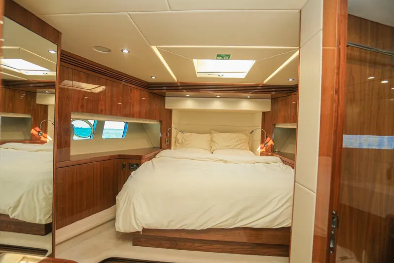  Yacht Photos Pics Luxurious bedroom interior of 2015 Sunseeker 75 Yacht with wood paneling and plush bedding.