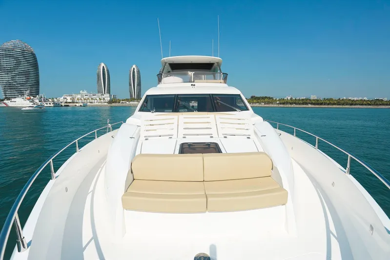  Yacht Photos Pics 2015 Sunseeker 75 Yacht cruising near modern waterfront buildings.