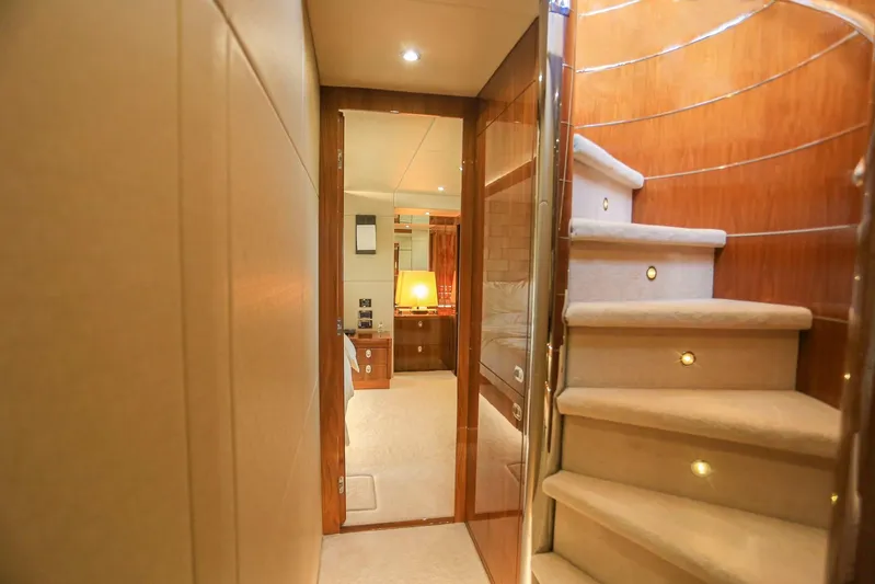  Yacht Photos Pics Luxurious interior of 2015 Sunseeker 75 Yacht with elegant staircase and cozy lighting.