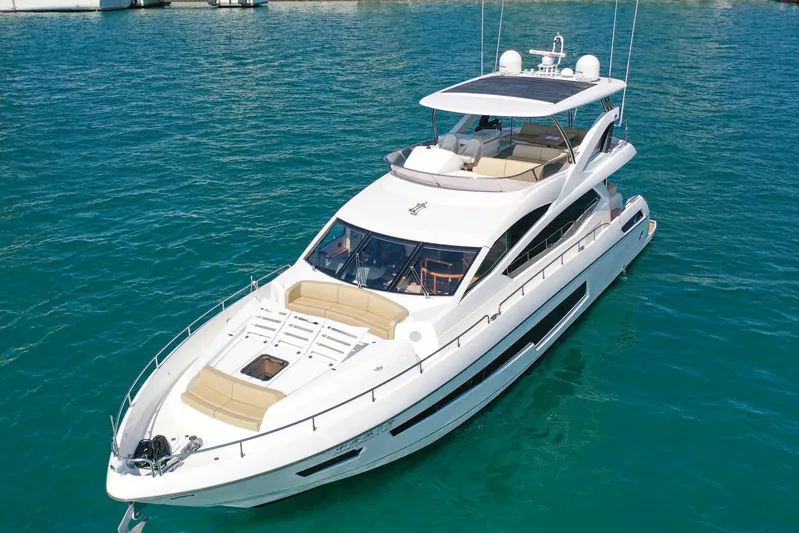  Yacht Photos Pics Luxurious 2015 Sunseeker 75 Yacht cruising on clear blue waters.