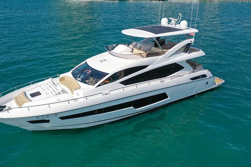  Yacht Photos Pics Luxurious 2015 Sunseeker 75 Yacht cruising on clear blue waters.