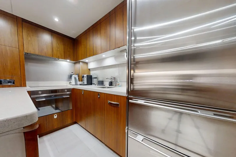 Glasax Yacht Photos Pics Luxurious kitchen interior of 2016 Sunseeker 75 Yacht with modern appliances and wood cabinetry.