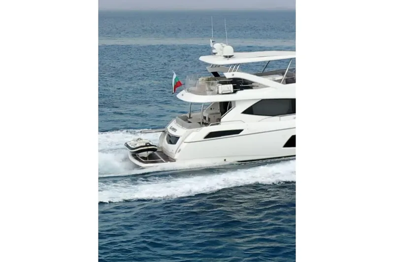 Glasax Yacht Photos Pics 2016 Sunseeker 75 Yacht cruising on open sea, rear view.