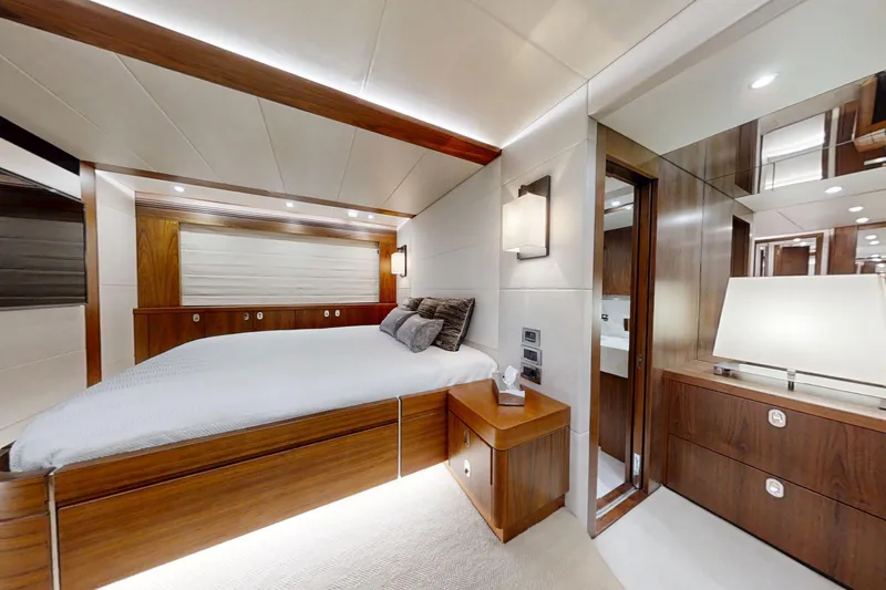 Glasax Yacht Photos Pics Luxurious bedroom interior of 2016 Sunseeker 75 Yacht with elegant wood finishes.