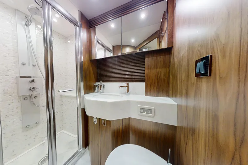 Glasax Yacht Photos Pics Luxurious bathroom in 2016 Sunseeker 75 Yacht with modern fixtures and wood accents.
