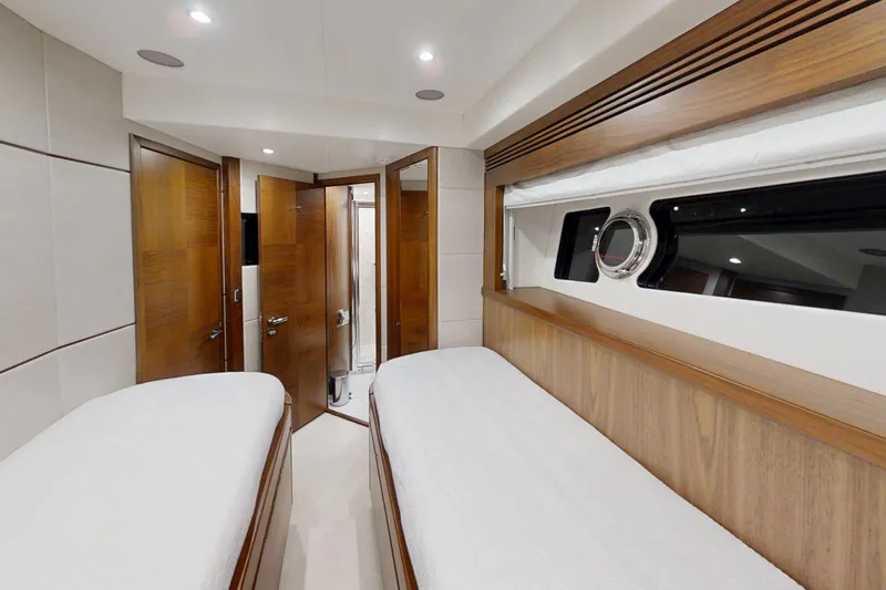 Glasax Yacht Photos Pics Luxurious interior cabin of 2016 Sunseeker 75 Yacht with twin beds and wooden accents.