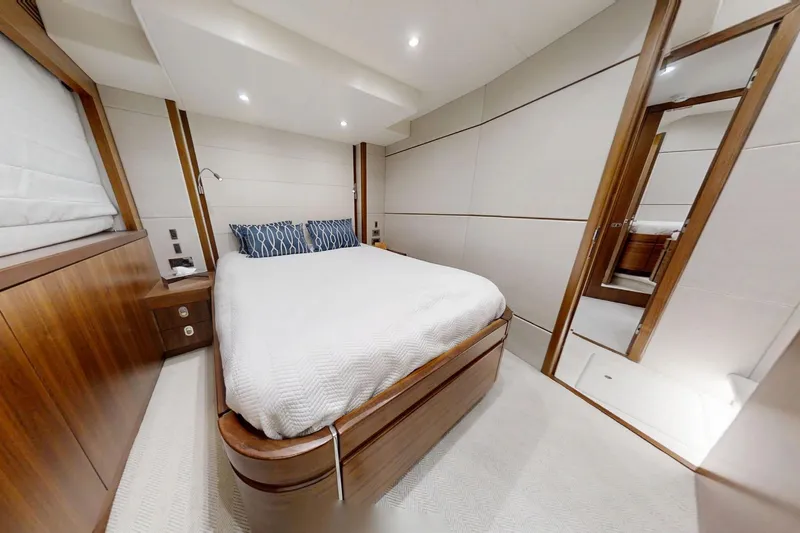 Glasax Yacht Photos Pics Luxurious bedroom interior of 2016 Sunseeker 75 Yacht with elegant wood finishes.