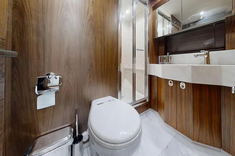 Glasax Yacht Photos Pics Luxurious bathroom in 2016 Sunseeker 75 Yacht with wood paneling and modern fixtures.