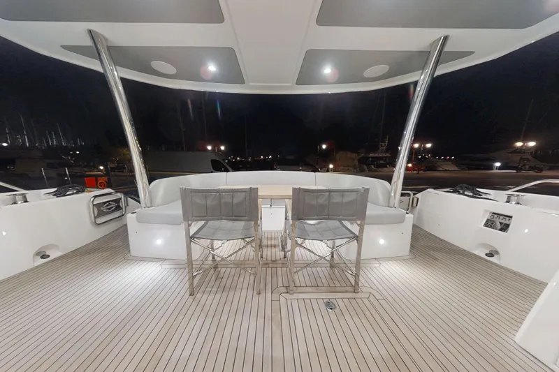 Glasax Yacht Photos Pics Luxurious 2016 Sunseeker 75 Yacht deck at night, featuring elegant seating and ambient lighting.