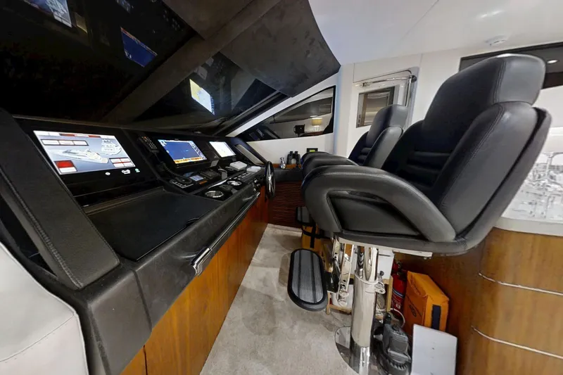 Glasax Yacht Photos Pics Interior helm of 2016 Sunseeker 75 Yacht with modern navigation controls and leather seating.