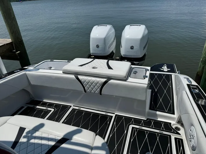  Yacht Photos Pics 2018 Statement 35 CC boat with dual outboard engines, featuring sleek black and white interior design.