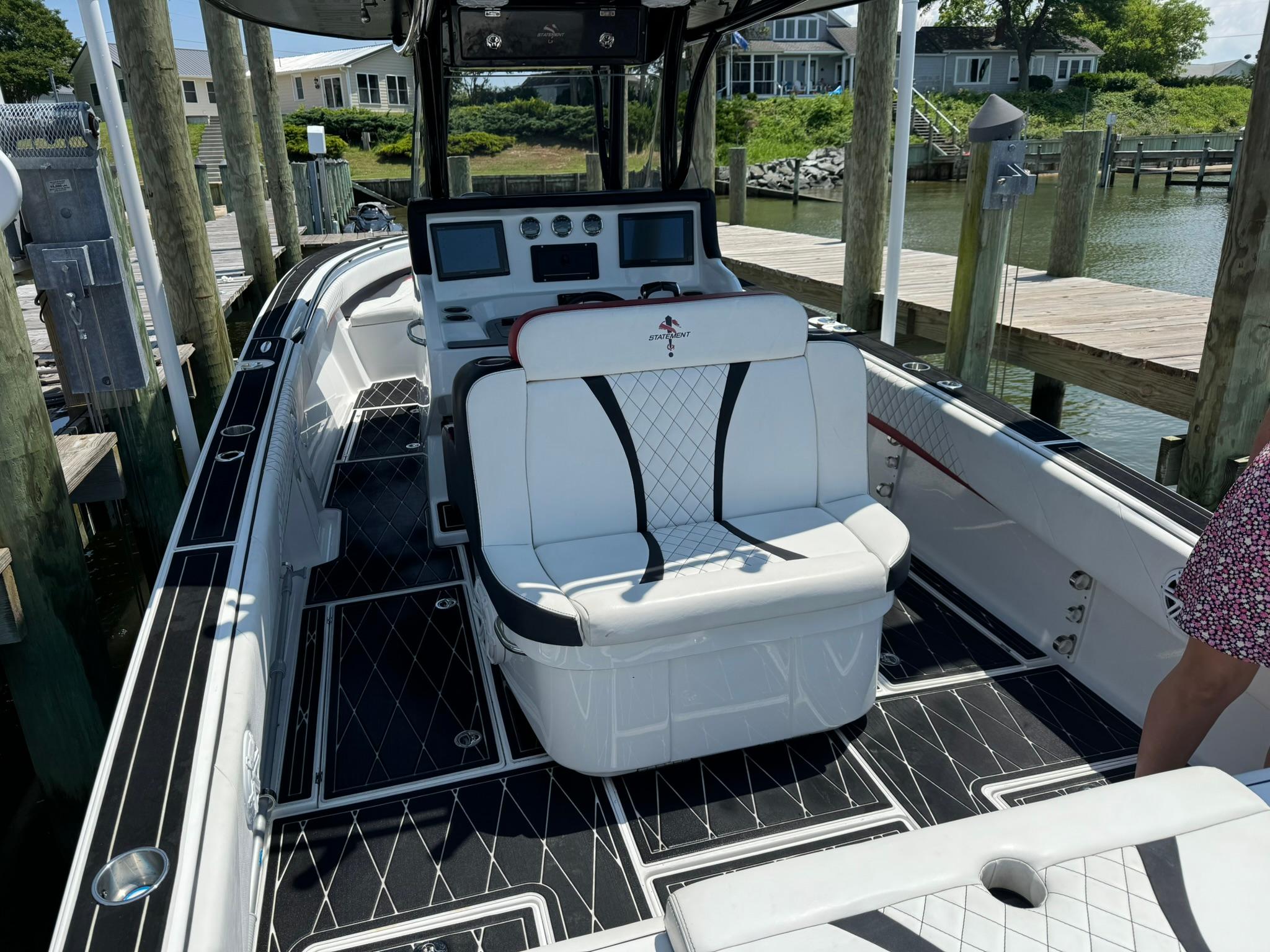 2018 Statement 35 CC boat with luxurious seating and modern dashboard at a dock.
