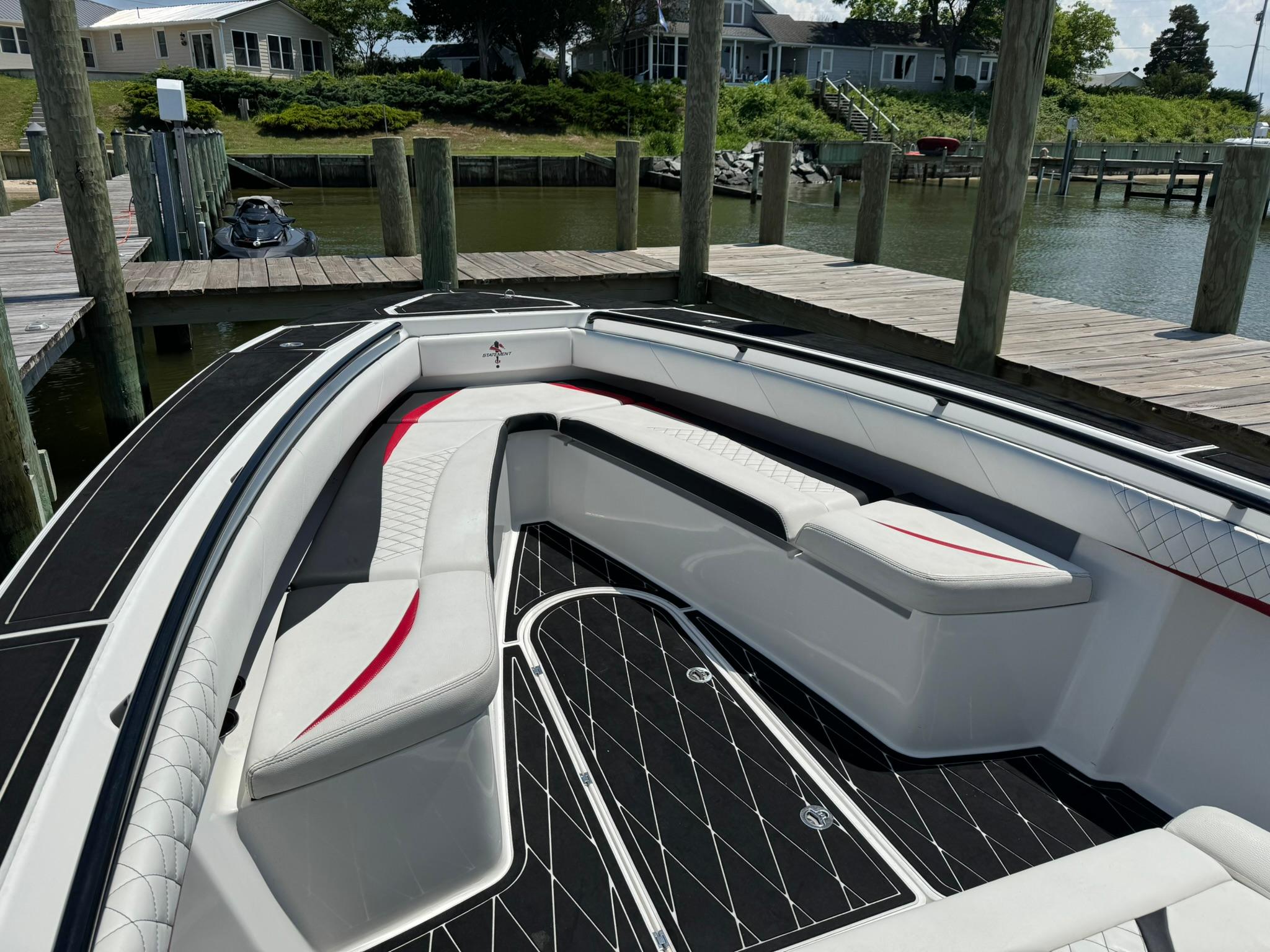 Luxurious 2018 Statement 35 CC boat with sleek seating at a dock.