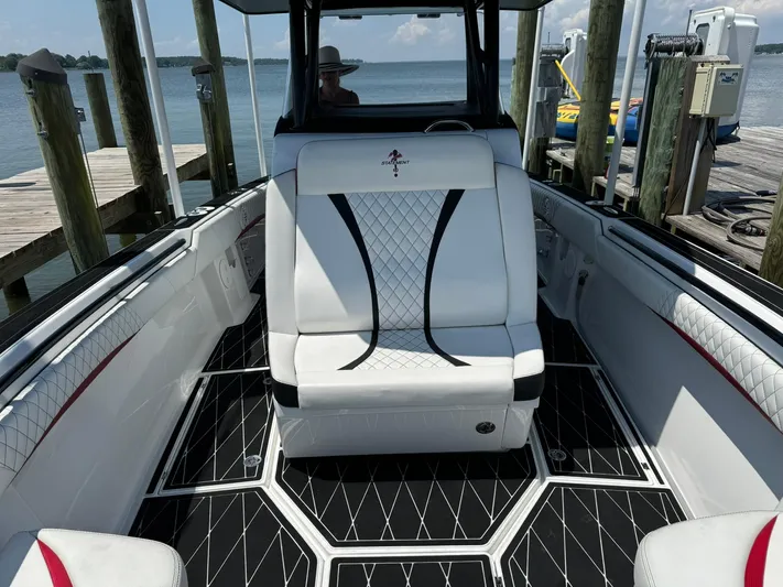  Yacht Photos Pics Luxurious 2018 Statement 35 CC boat interior with white seating and black accents at a dock.