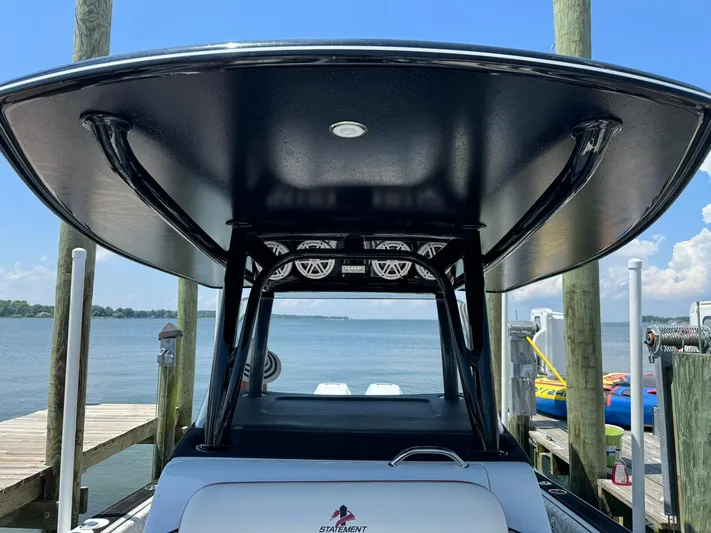  Yacht Photos Pics 2018 Statement 35 CC boat docked, featuring a sleek T-top and scenic waterfront view.
