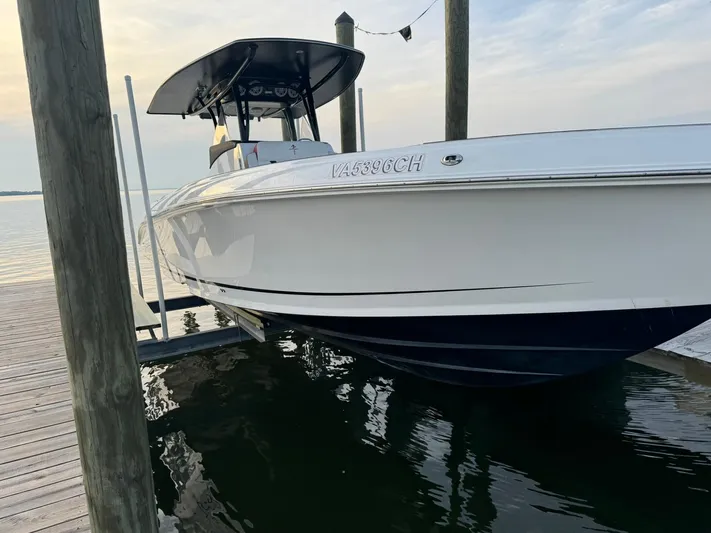  Yacht Photos Pics 2018 Statement 35 CC boat docked on calm water at sunset.