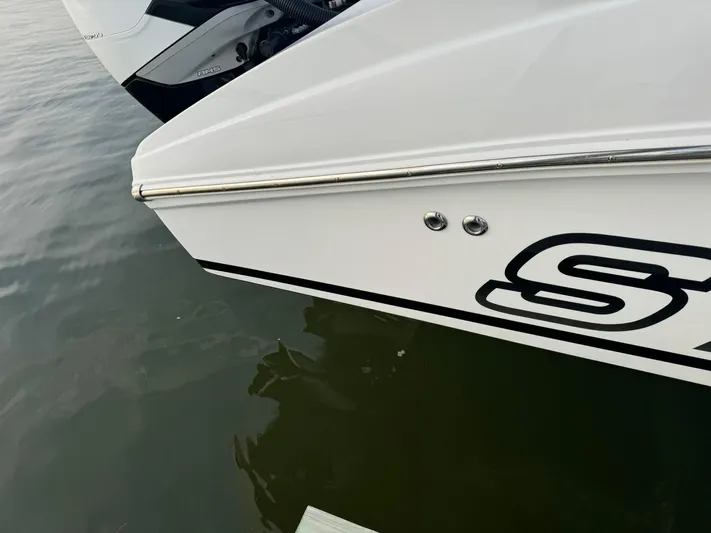  Yacht Photos Pics Close-up of a 2018 Statement 35 CC boat's sleek white hull on water.