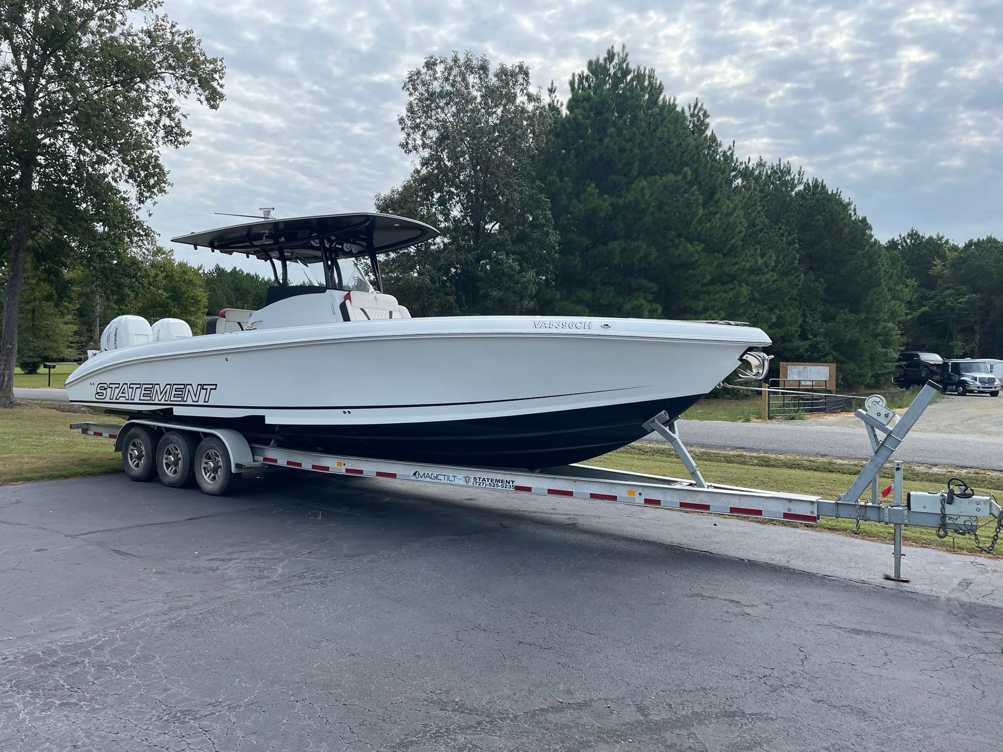 2018 Statement 35 CC boat on trailer, parked outdoors with trees in background.