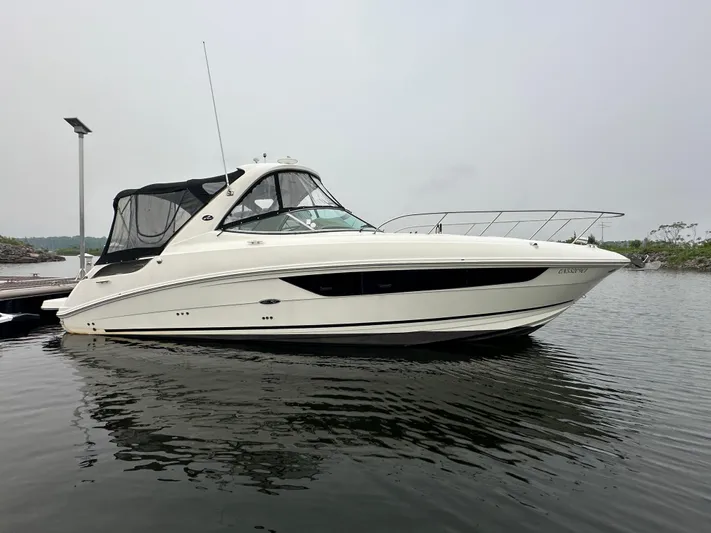  Yacht Photos Pics 2017 Sea Ray Sundancer 310 yacht docked on calm water.